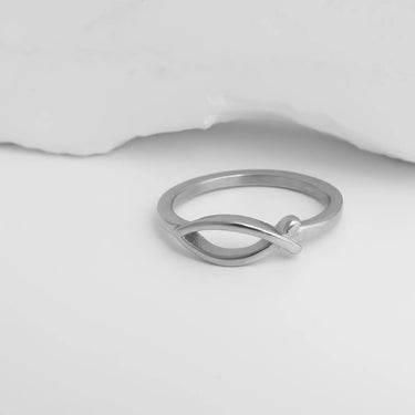 Silver ring with a unique design on a white background