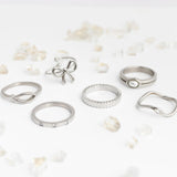 Collection of silver rings on a light background