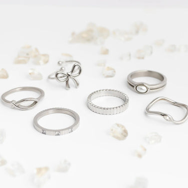 Collection of silver rings on a light background