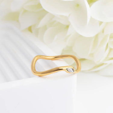 Gold ring with a diamond on a white flower background