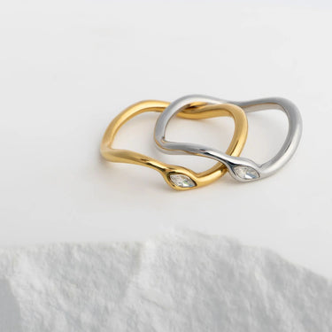 Two gold and silver rings on a white surface