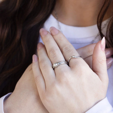 Close-up of hands with silver rings on fingers