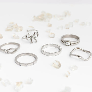 Collection of silver rings on a light background