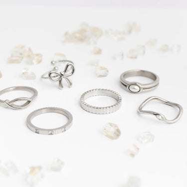 Collection of silver rings on a light background