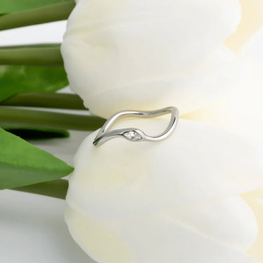 Silver ring with a small diamond on a white flower