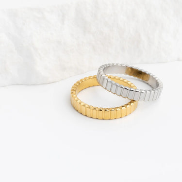 Two gold and silver rings on a white background