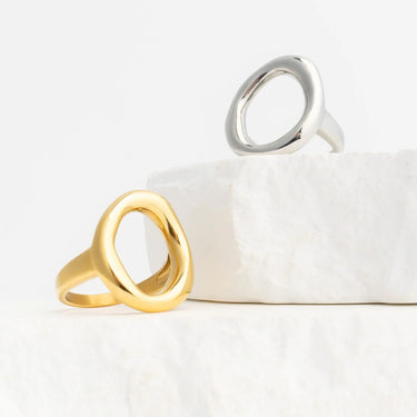 Gold and silver Oval Motif Rings on a white surface