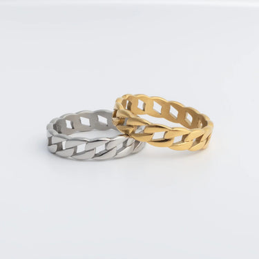Two Curb Chain Stacking Rings, one silver and one gold, on a light gray background