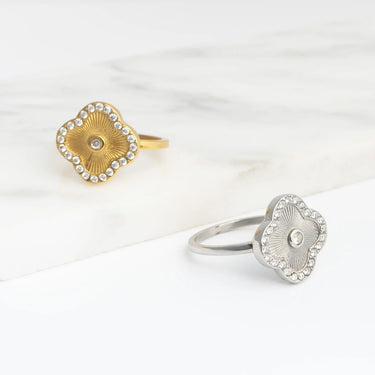 Gold and silver Floral Motif Rings with decorative designs on a white background