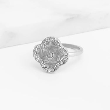 Silver Floral Motif Ring with a textured design and clear stones on a white background