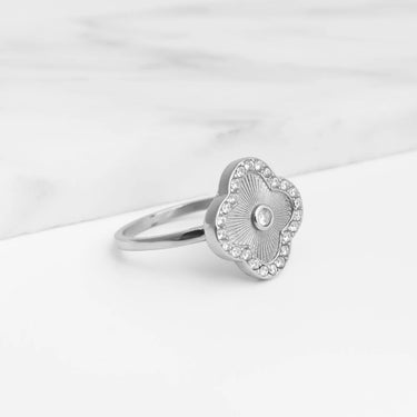 Silver Floral Motif Ring with floral design on a white marble surface