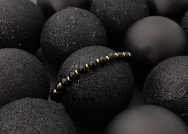 Black beaded bracelet on black textured stones
