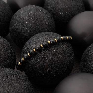 Black beaded bracelet on black textured stones
