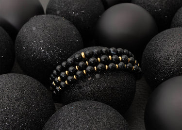 Black beaded bracelet on black stones