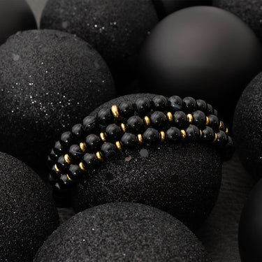Black beaded bracelet on black stones