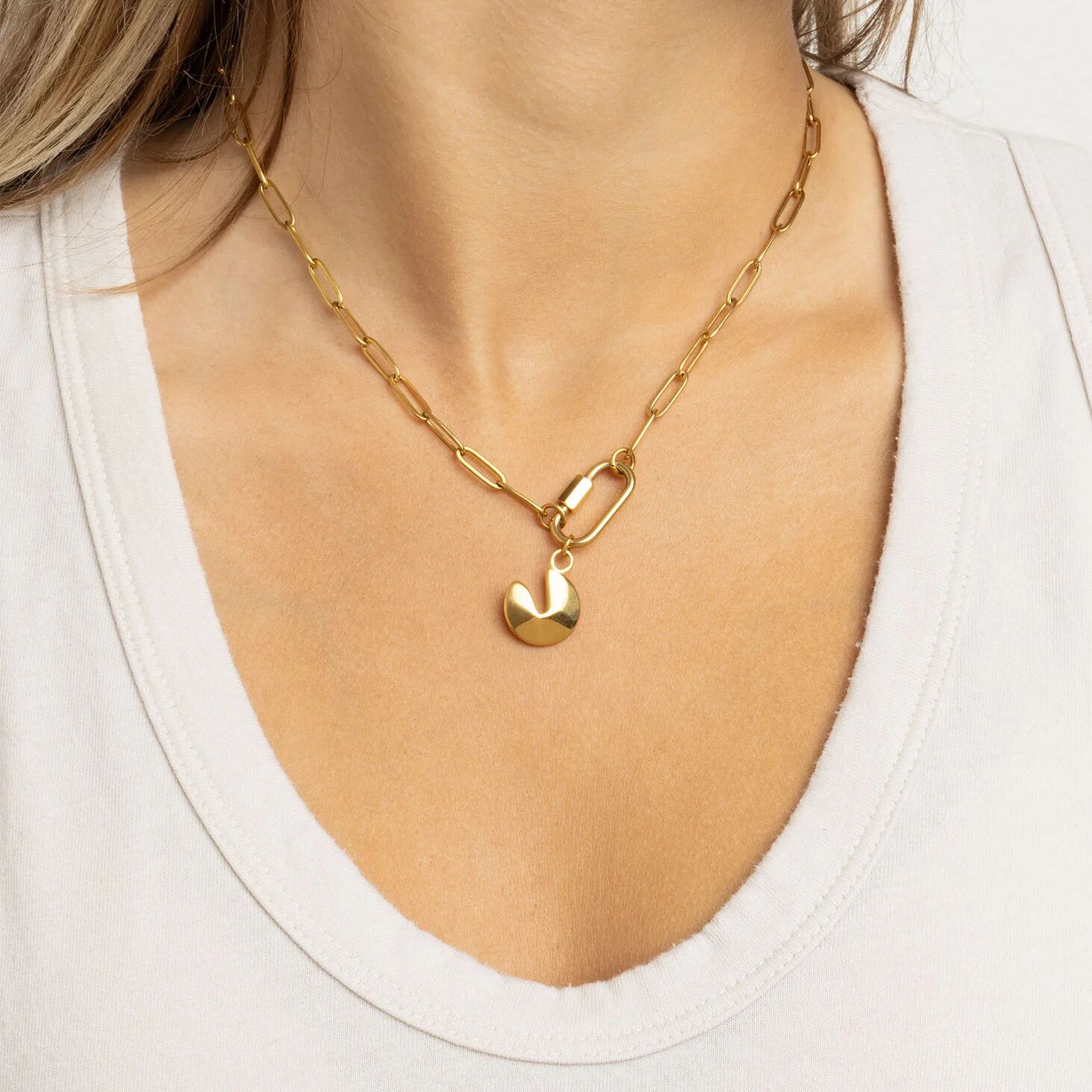 Gold chain necklace with a Fortune Cookie Charm worn by a person on a white background