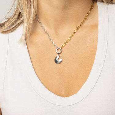 Spilt chain necklace with Fortune Cookie Charm on a person wearing a white top.