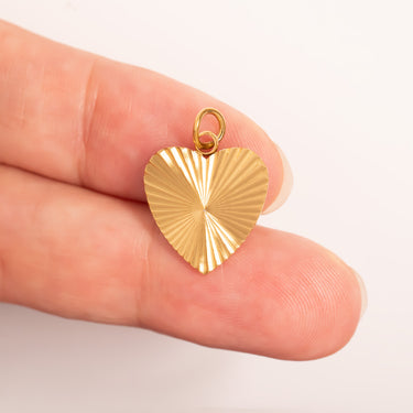 Gold Sunburst Heart Charm- scale shot 
