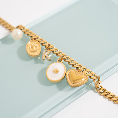 White Enamel Charm with Shell, On curb chain bracelet, with other charms