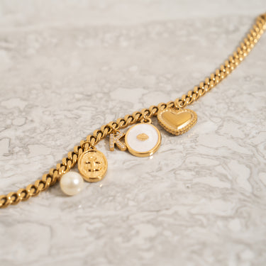 White Enamel Charm with Shell, On curb chain bracelet, with other charms