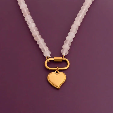 Necklace with a gold heart pendant on a purple background