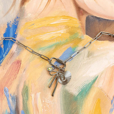 Necklace with charms on a colorful abstract painting background