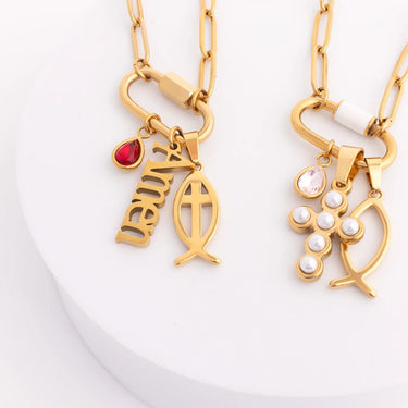 Two gold necklaces with fish-shaped pendants on a white background