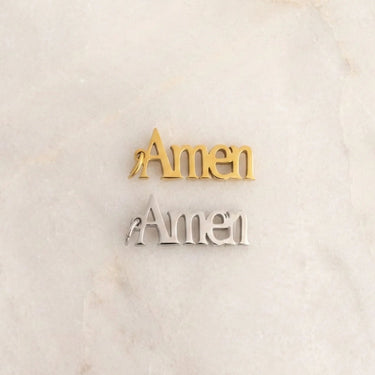 Gold and silver 'Amen' decorations on a marble surface