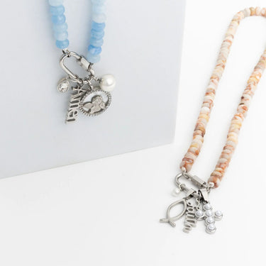 Two beaded necklaces with charms on a white background