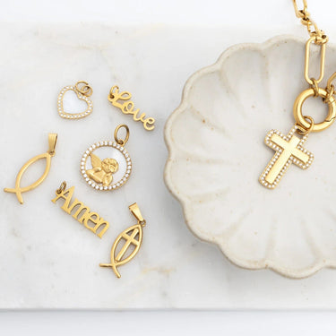 Collection of gold pendants on a marble surface