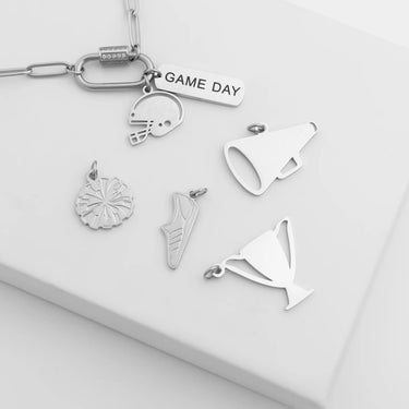 Collection of silver keychain charms on a white surface