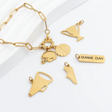Gold bracelet with various charms on a white background