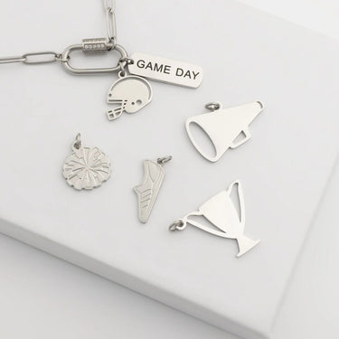 Collection of silver keychain charms on a white background