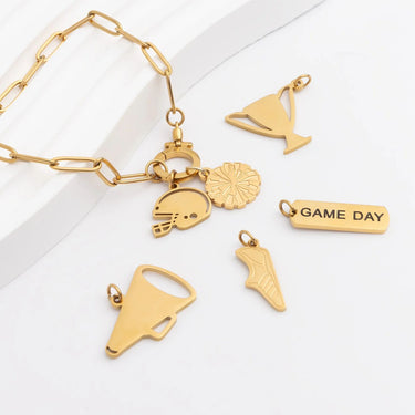 Gold bracelet with various charms on a white background