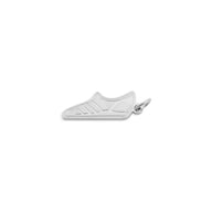 Silver shoe-shaped pendant on a white background