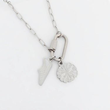 Silver necklace with two pendants on a white background