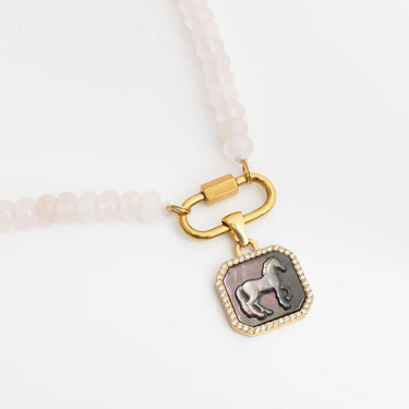 Bracelet with gold clasp and dog pendant on a white background