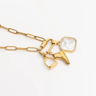 Gold necklace with horse and heart-shaped pendants on a white background