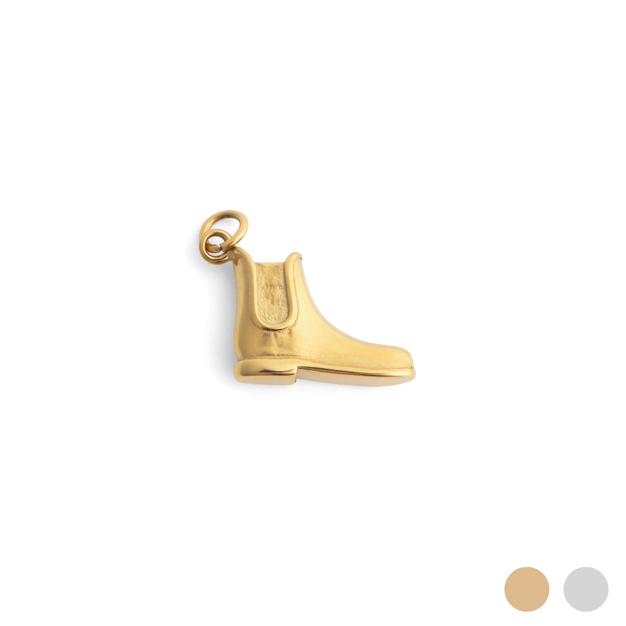 Gold boot charm on a white background