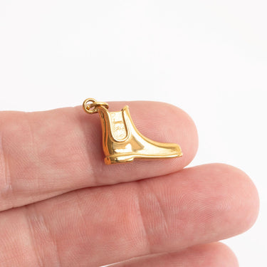 Gold boot charm on finger for scale shot 