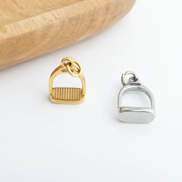Gold and silver equestrian-themed pendants on a white background