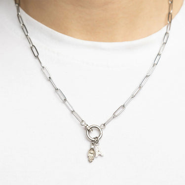 Silver chain necklace with a pendant on a white background