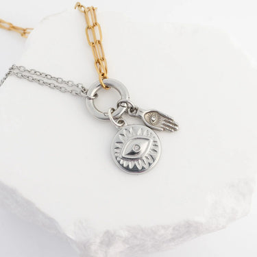 Two necklaces with charms on a white background