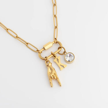 Gold necklace with charms on a white background