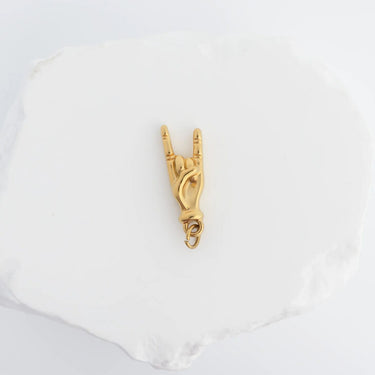 Gold equestrian-themed pendant on a white background