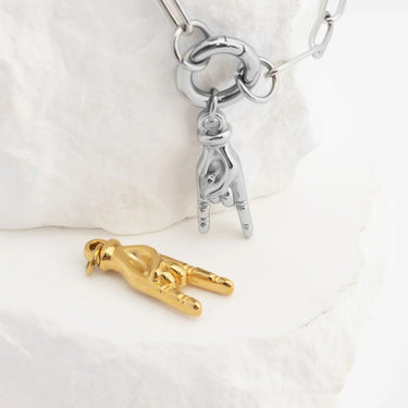 Silver and gold charm on a white background