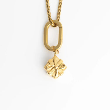 Gold necklace with a Present Charm on a white background
