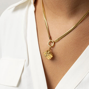 Gold necklace with a gift box Present Charm on a white background