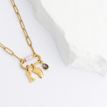 Gold necklace with Baby Foot Charm on a white background