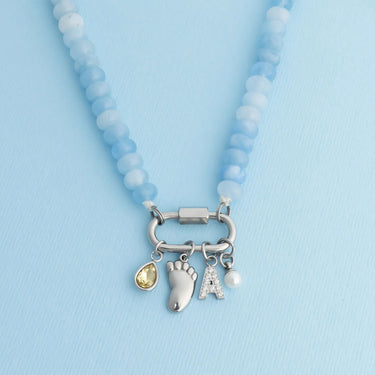 Necklace with Baby Foot Charm on a light blue background